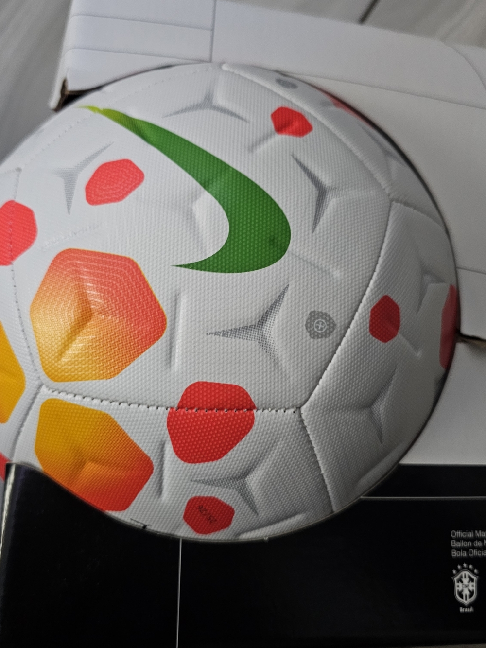 Nike White Soccer Ball with Green Swoosh and Red/Orange Accents